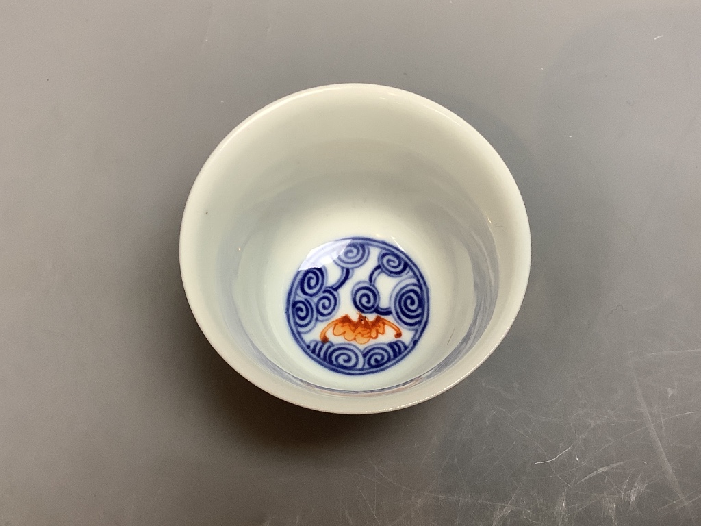 A Chinese underglaze blue and iron red 'bat' cup, height 6cm